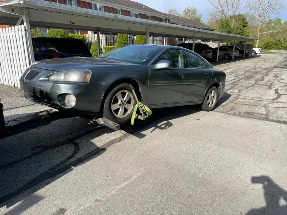 Older sedan being loaded for pickup in Indianapolis after its owner replaced a lost title with a duplicate title in Indiana