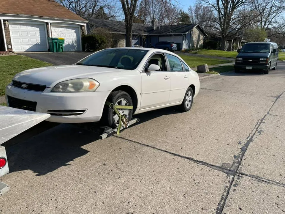 A junk car pickup on a quiet Indianapolis street, one of hundreds Cash Car Heroes hauls across Central Indiana