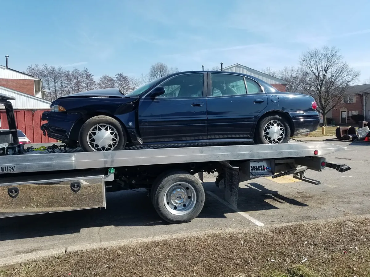 Sell a wrecked car in Indianapolis: dark blue sedan with heavy front-end collision damage awaiting a cash offer